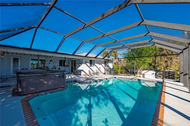 view of swimming pool featuring a lanai, a patio area, and a hot tub