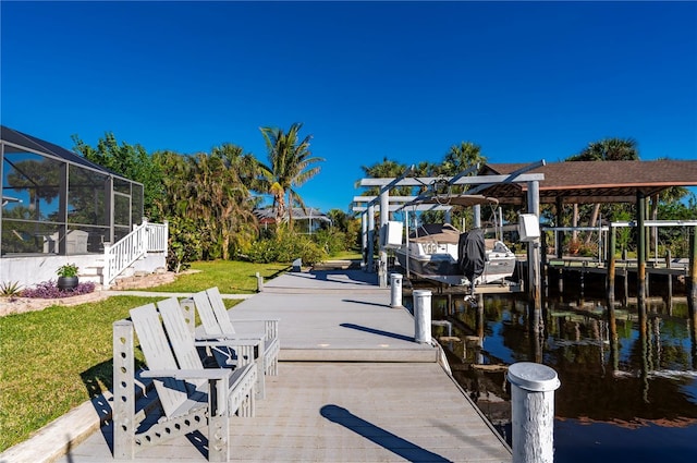 dock area featuring a lawn, glass enclosure, and a water view