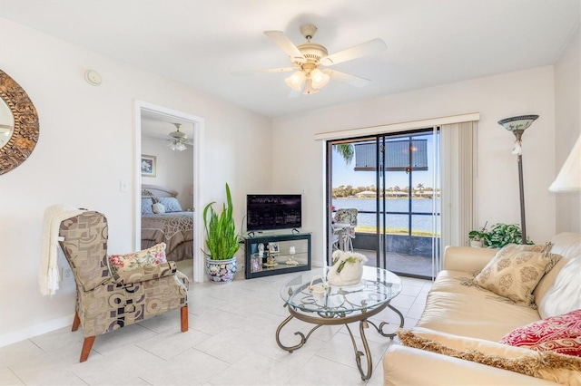 living room with ceiling fan and light tile patterned floors