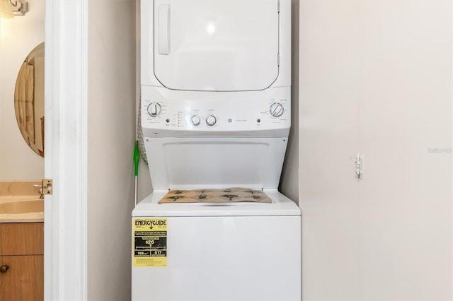 laundry area with sink and stacked washer and dryer