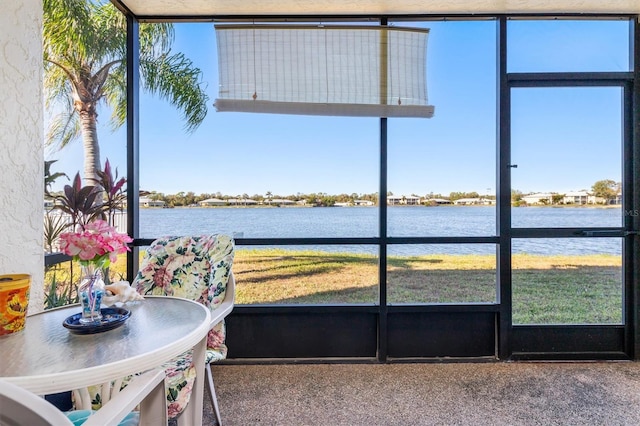 sunroom / solarium with a water view