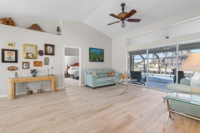 living room with ceiling fan, high vaulted ceiling, and light hardwood / wood-style flooring