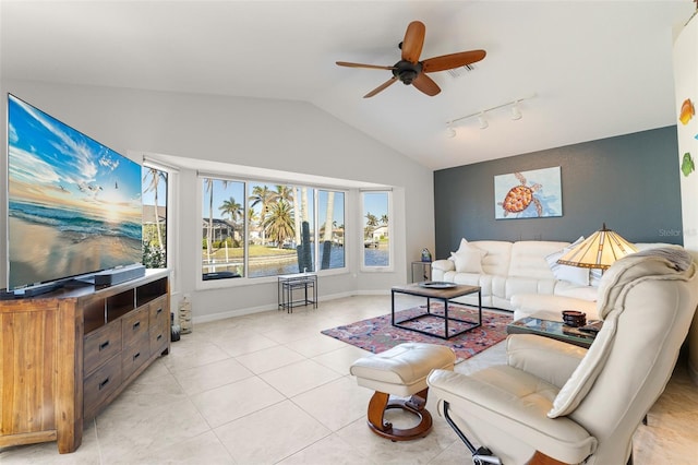 living room featuring ceiling fan, track lighting, lofted ceiling, a water view, and light tile patterned floors