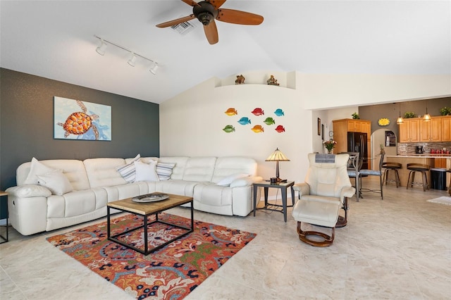 living room with ceiling fan and vaulted ceiling