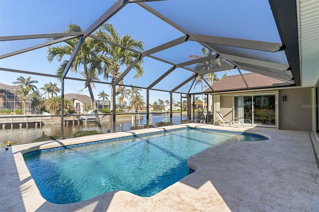 view of swimming pool featuring glass enclosure, a water view, and a patio