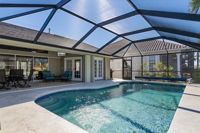 view of pool featuring ceiling fan, a patio area, glass enclosure, and french doors