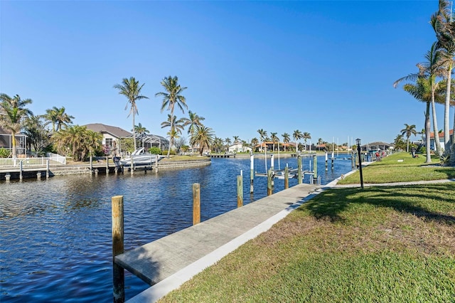 dock area with a water view and a lawn