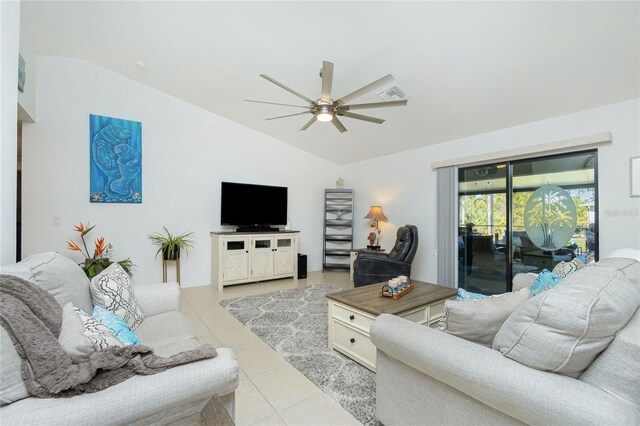 living room featuring ceiling fan, light tile patterned floors, and lofted ceiling