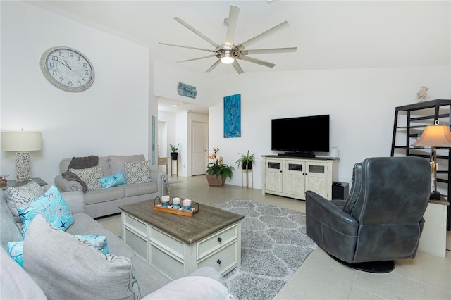 tiled living room featuring ceiling fan and lofted ceiling