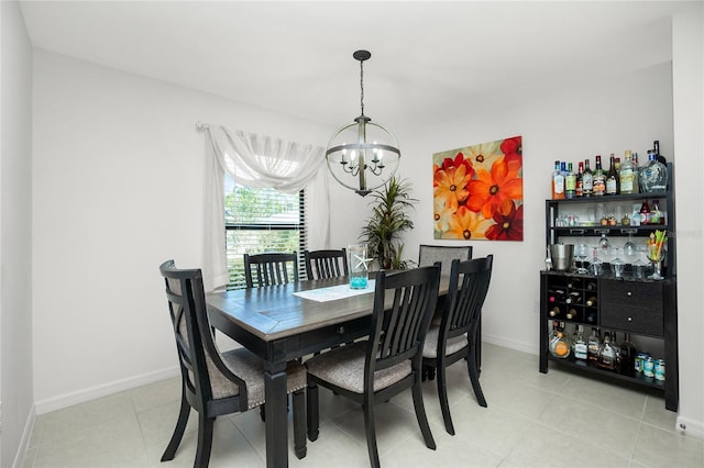 dining space with light tile patterned floors and a chandelier