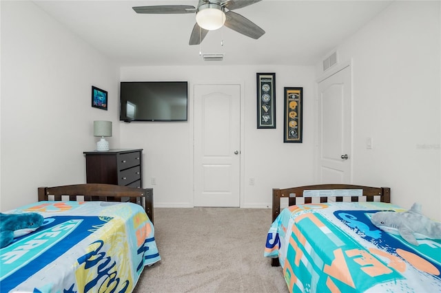 bedroom with ceiling fan and light carpet