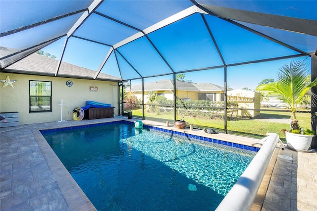 view of swimming pool featuring a patio area and a lanai