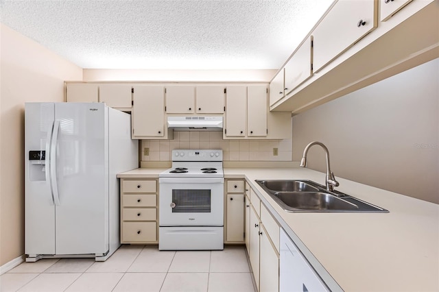 kitchen with white appliances, cream cabinets, sink, light tile patterned floors, and tasteful backsplash