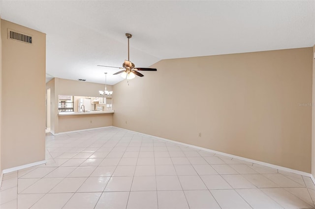 tiled empty room featuring a textured ceiling, ceiling fan with notable chandelier, lofted ceiling, and sink