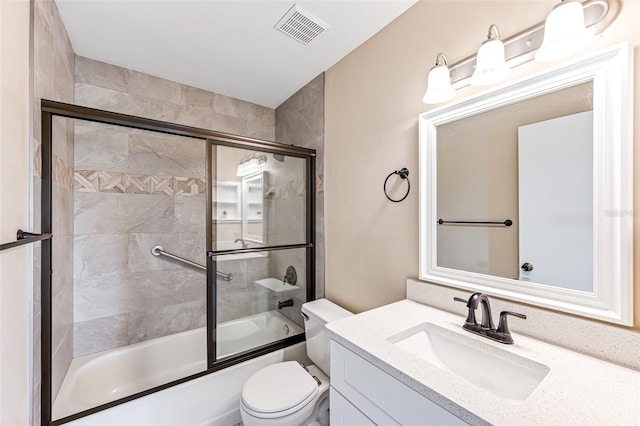 full bathroom with combined bath / shower with glass door, vanity, and toilet