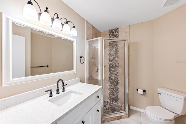 bathroom with tile patterned floors, toilet, vanity, and walk in shower