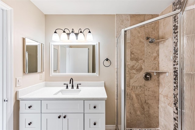 bathroom with a shower with door and vanity