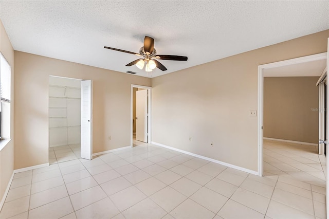 unfurnished bedroom featuring ceiling fan, a closet, and a textured ceiling