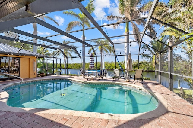 view of pool featuring a water view, a patio area, and a lanai