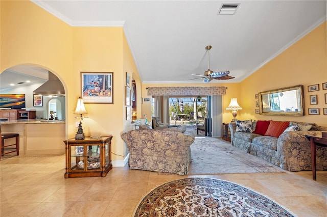 tiled living room with ceiling fan, crown molding, and vaulted ceiling