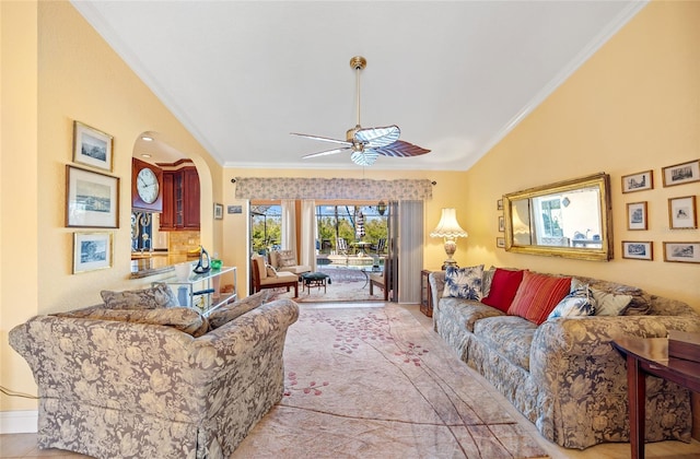 living room with ceiling fan, ornamental molding, and lofted ceiling