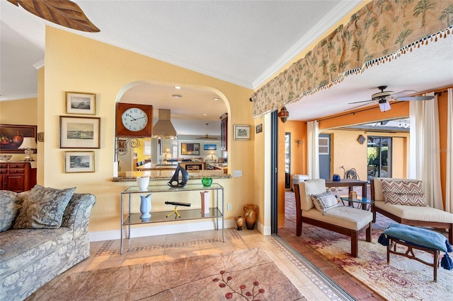 tiled living room featuring a textured ceiling, ceiling fan, and crown molding