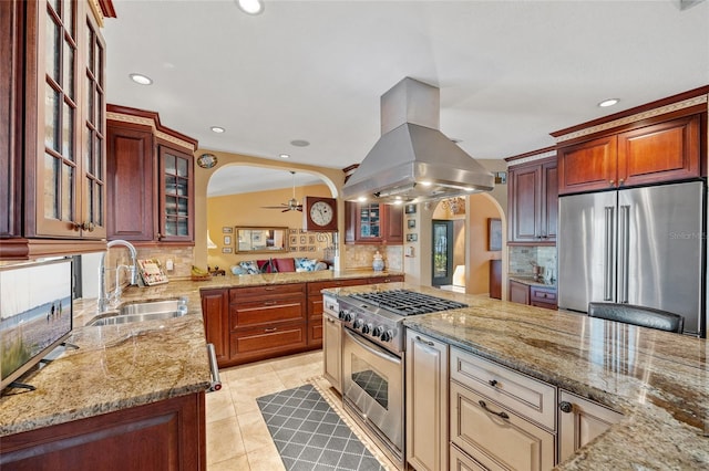 kitchen with sink, decorative backsplash, high end appliances, and island exhaust hood