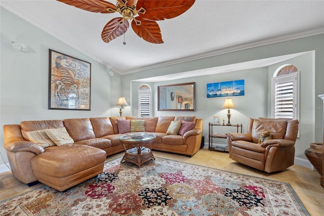 tiled living room with vaulted ceiling, ceiling fan, and crown molding