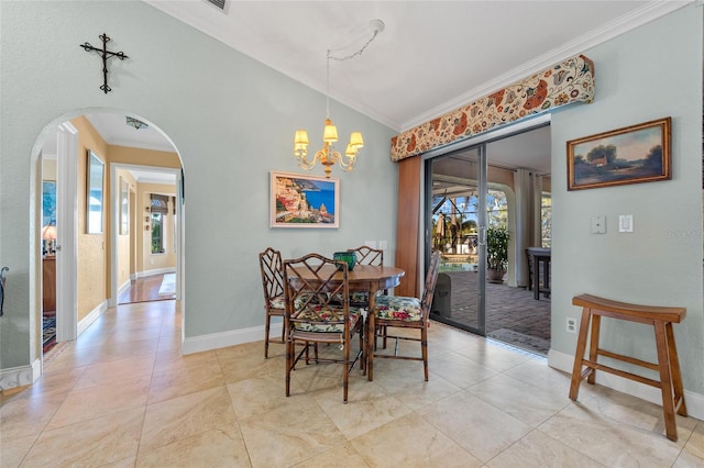 dining room featuring a chandelier, lofted ceiling, and crown molding