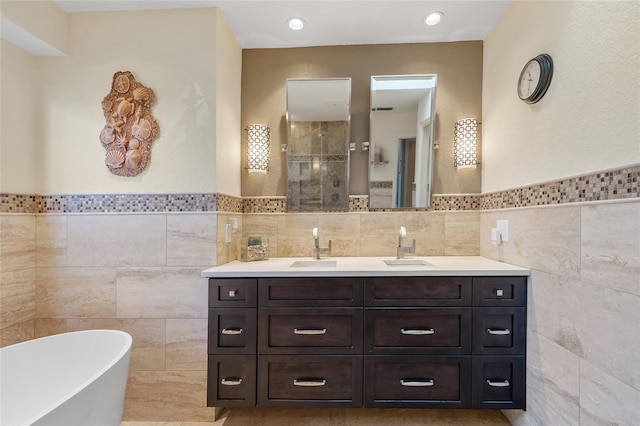 bathroom featuring vanity, tile walls, and independent shower and bath