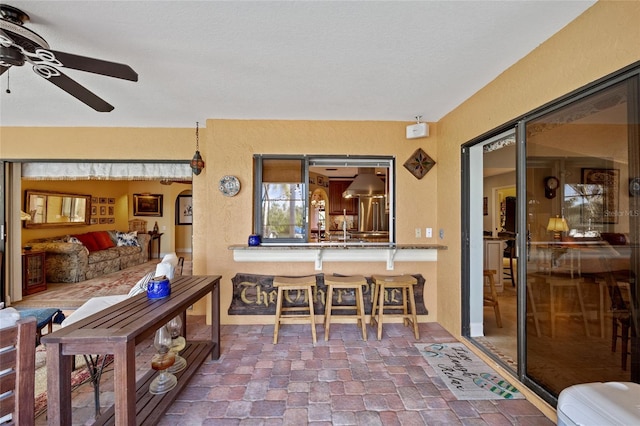 interior space featuring a textured ceiling and ceiling fan