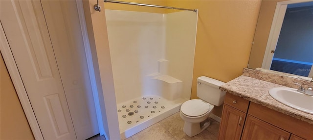 bathroom with tile patterned floors, toilet, a shower, and vanity