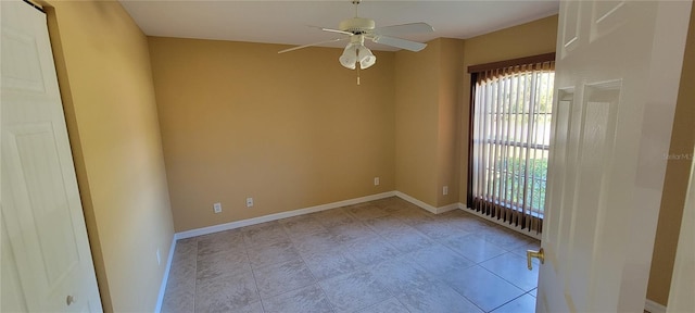 tiled empty room with ceiling fan