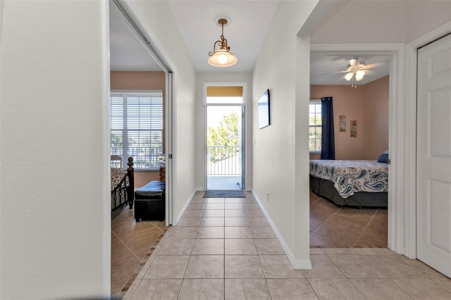 foyer entrance featuring ceiling fan and light tile patterned flooring