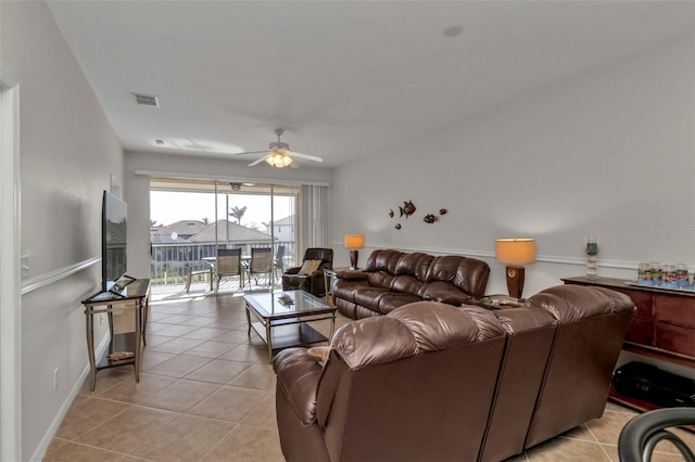 tiled living room with ceiling fan