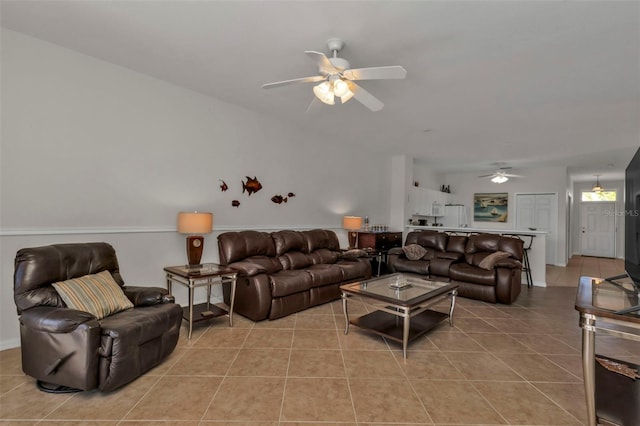 tiled living room with ceiling fan