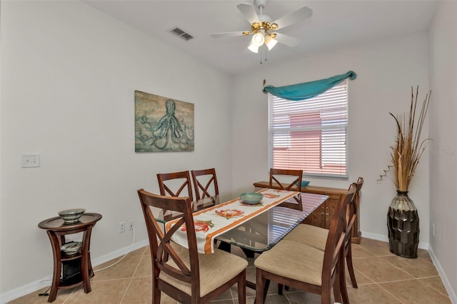 dining space featuring ceiling fan and light tile patterned flooring