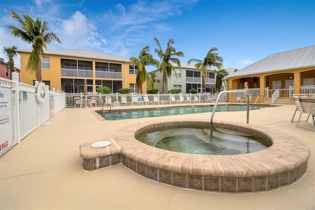 view of pool featuring a community hot tub and a patio