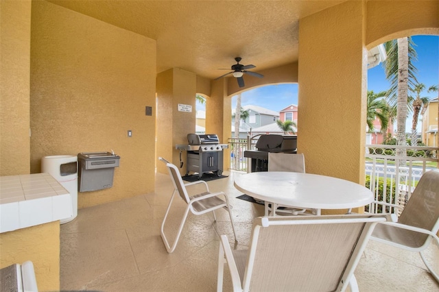 view of patio / terrace with ceiling fan and a grill