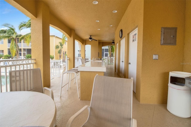 view of patio / terrace with ceiling fan and electric panel