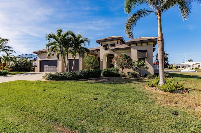 mediterranean / spanish-style house featuring a front lawn and a garage