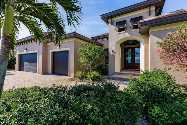 doorway to property with french doors and a garage