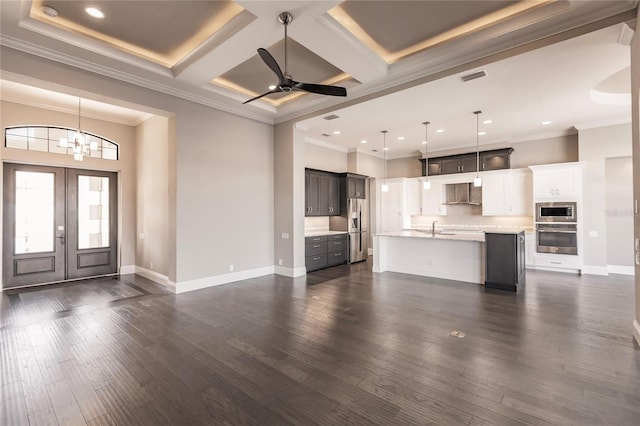 unfurnished living room with french doors, coffered ceiling, ceiling fan with notable chandelier, crown molding, and dark hardwood / wood-style floors