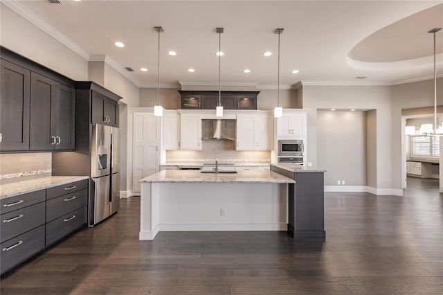 kitchen featuring pendant lighting, a center island with sink, wall chimney range hood, sink, and dark hardwood / wood-style flooring