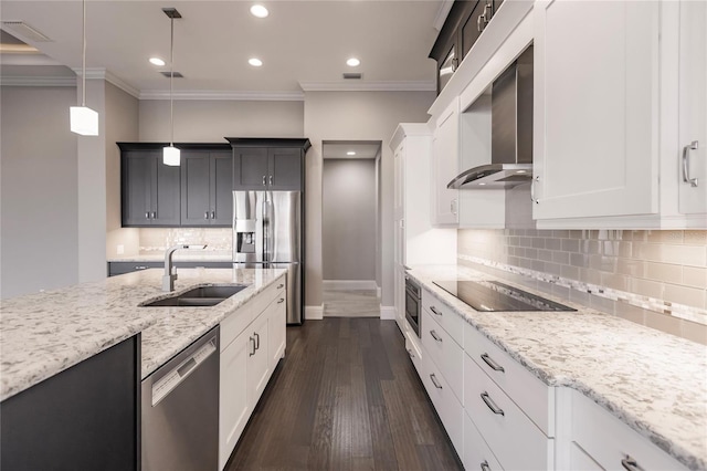 kitchen featuring appliances with stainless steel finishes, dark hardwood / wood-style flooring, sink, decorative light fixtures, and white cabinets