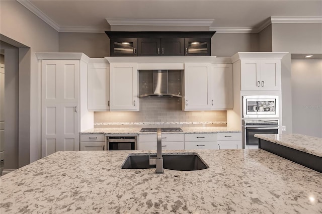 kitchen with white cabinetry, sink, wall chimney exhaust hood, stainless steel appliances, and light stone counters