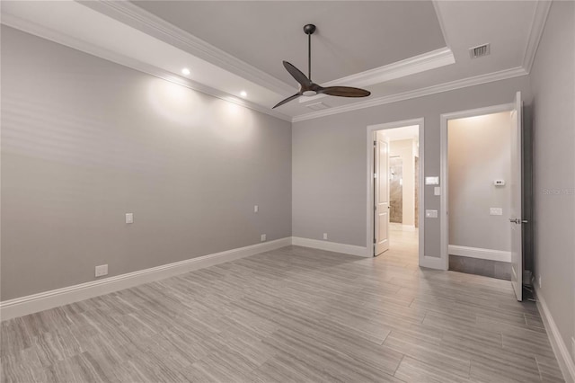 unfurnished room featuring ceiling fan, light wood-type flooring, and ornamental molding