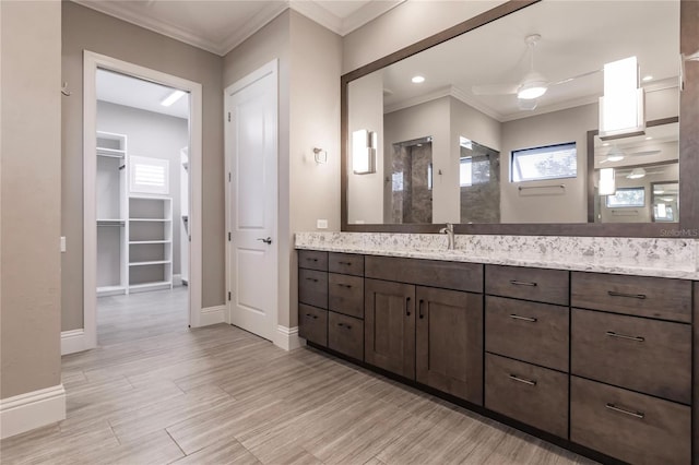 bathroom with vanity, a shower, crown molding, ceiling fan, and wood-type flooring