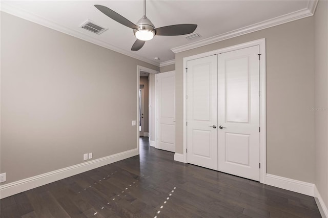 unfurnished bedroom with ceiling fan, a closet, crown molding, and dark hardwood / wood-style floors