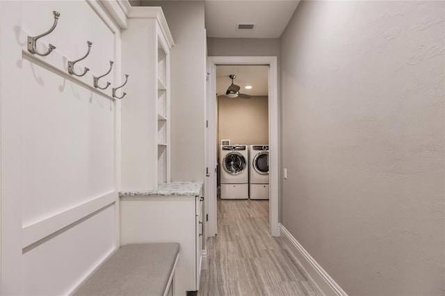 washroom featuring washer and dryer and light hardwood / wood-style floors